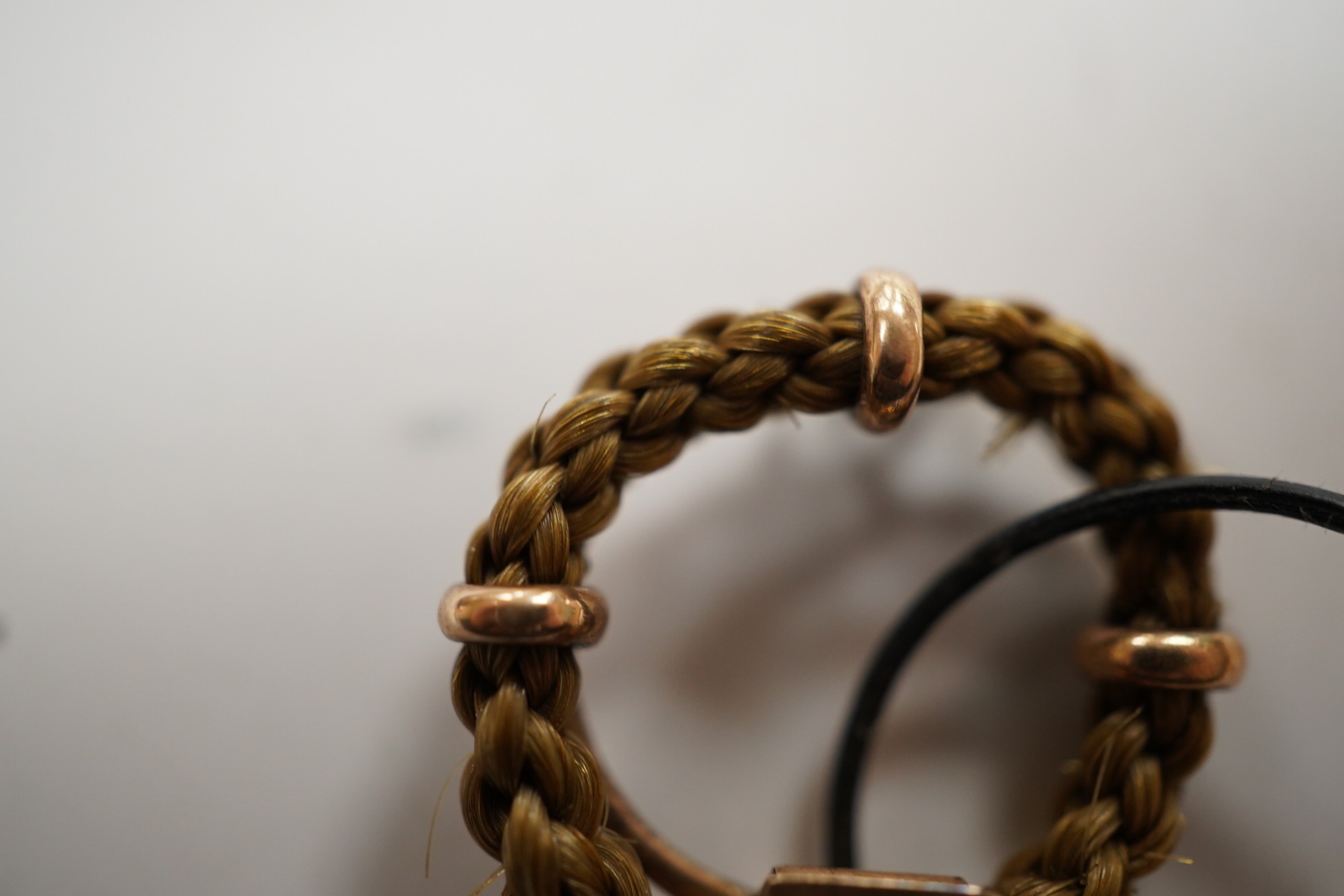 An early 19th century hairwork brooch, with engraved initials and a small hairwork ring. Condition - fair.